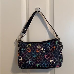 Small coach zip top bag with short strap.